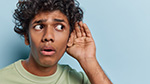 Person listening to odd sounds coming from their air conditioner